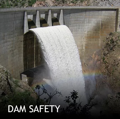 Strontia Springs dam spillway with a cascading waterfall and rainbow in the foreground